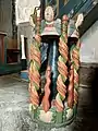 The richly decorated wooden baptismal font