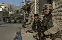 U.S. soldiers wearing the DCU uniform with the 25th Infantry Division SSI.