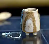 Alabaster jar with a necklace from Tell es-Sawwan, Iraq. 6000-5800 BCE. Iraq Museum