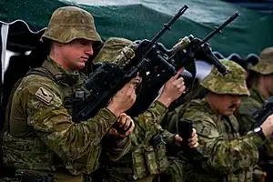 Australian soldiers with AN/PEQ-15s mounted to the top of the receiver of the Australian EF88