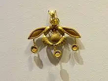 The Bee Pendant, an iconic Minoan jewel; 1700–1600 BC; gold; width: 4.6 centimetres (1.8 in); from Chrysolakkos (gold pit) complex at Malia; Archaeological Museum of Heraklion (Heraklion, Greece)