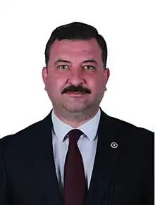 Portrait photograph of Ekrem Gökay Yüksel in a suit