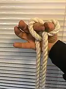 6. The index finger and the thumb are joined to gather the final knot.