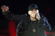 Eminem in military gear rapping into a microphone