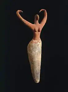 Image 3Naqada figure of a woman interpreted to represent the goddess Bat with her inward curving horns. Another hypothesis is that the raised arms symbolize wings and that the figure is an early version of the white vulture goddess Nekhbet, c. 3500–3400 B.C.E. terracotta, painted, 11+1⁄2 in × 5+1⁄2 in × 2+1⁄4 in (29.2 cm × 14.0 cm × 5.7 cm), Brooklyn Museum (from Prehistoric Egypt)
