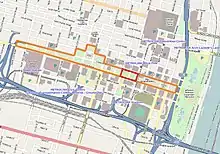 In the middle of a colored road map, a long strip of land is outlined in orange, while a small rectangle within this strip is outlined in red.