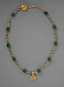 Necklace with a medallion depicting a goddess; 30–300 AD; green glass (the green beads) and gold; length: 43.82 centimetres (17.25 in); Los Angeles County Museum of Art