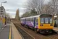 A Northern Rail Class 142 waits at the station.