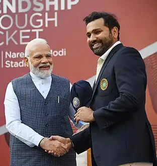 Rohit Sharma being presented his match cap by PM Modi.