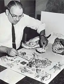 An engineer examines a broken flight recorder