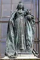 A statue of a crowned Queen Victoria, holding a scepter and orb.