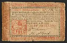 A 8s Pennsylvania note issued in 1777 with the inscription: ""THIS Bill shall pass current for EIGHT SHILLINGS, according to an Act of GENERAL ASSEMBLY of the Common Wealth of Pennsylvania, passed the Twentieth Day of March, in the Year One Thousand Seven Hundred and Seventy-seven. Dated the Tenth Day of April, A.D. 1777. EIGHT SHILLINGS."Vers ; Verso: "Eight Shillings. To Counterfeit is DEATH. PHILADELPHIA: Printed by JOHN DUNLAP. 1777."