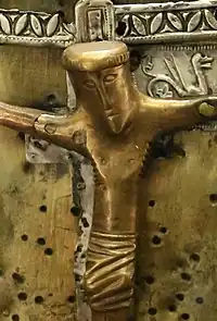 Detail of Jesus on the cross. He seems to be dead, given his closed eyes and drooping head.