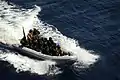 A rigid-hull inflatable boat operated by the SAT unit transfers members of a visit, board, search and seizure team to the Military Sealift Command maritime prepositioning and force container roll-on roll-off and tanker USNS LCPL Roy H. Wheat (T-AK 3016) during the at sea portion of exercise Phoenix Express (PE 10).