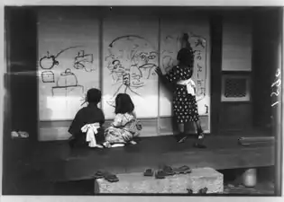 Children playing on an engawa; they are drawing on the shōji. Note shoes on fume-ishi.